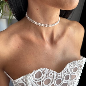 5 ideias de títulos:
1. Gargantilhas de Noiva: Tendências 2026 e Como Escolher a Perfeita
2. Minimalismo vs. Maximalismo: A Escolha da Gargantilha Ideal para Seu Casamento
3. Guia Completo: Combinando Gargantilhas com Decotes de Vestidos de Noiva
4. Pérolas